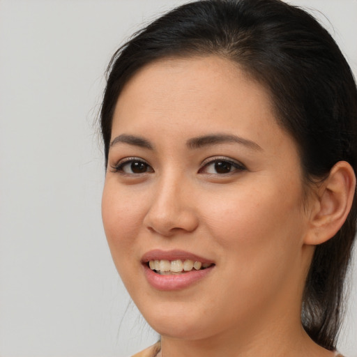 Joyful asian young-adult female with long  brown hair and brown eyes