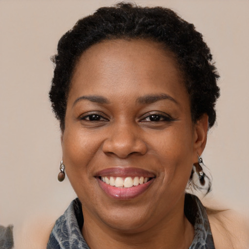 Joyful black adult female with short  brown hair and brown eyes