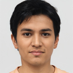 Joyful asian young-adult male with short  black hair and brown eyes