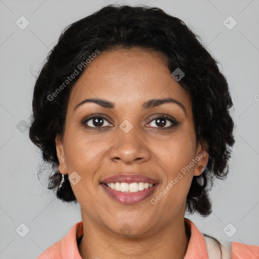 Joyful black adult female with medium  brown hair and brown eyes