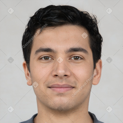 Joyful latino young-adult male with short  brown hair and brown eyes