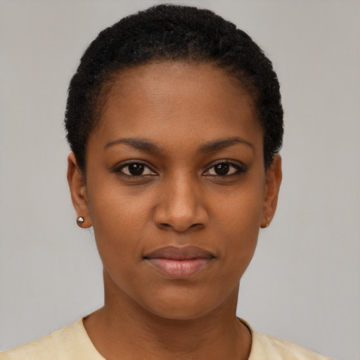 Joyful black young-adult female with short  black hair and brown eyes