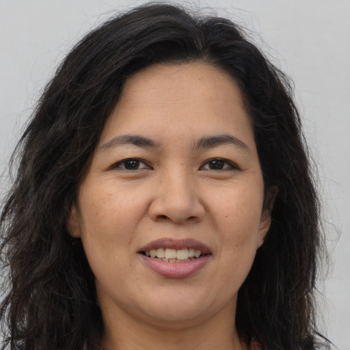 Joyful asian adult female with long  brown hair and brown eyes