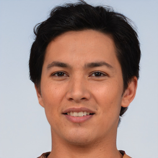 Joyful asian young-adult male with short  brown hair and brown eyes