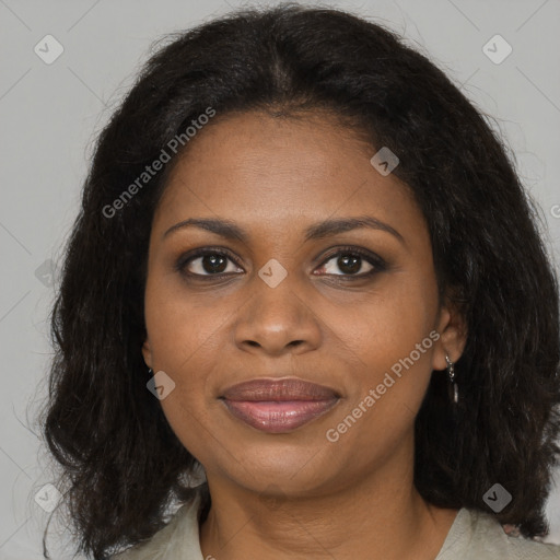 Joyful black adult female with medium  brown hair and brown eyes