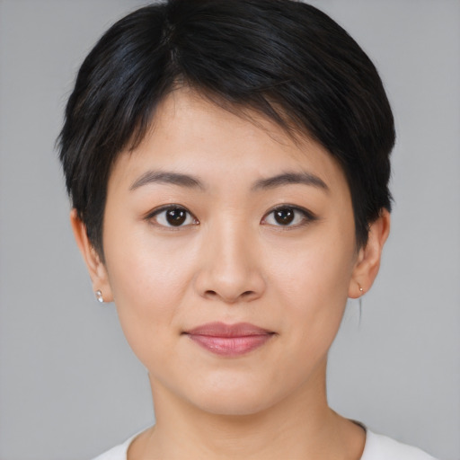 Joyful asian young-adult female with short  brown hair and brown eyes