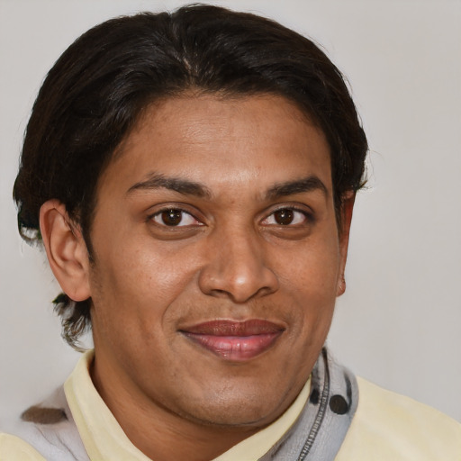 Joyful latino adult male with short  brown hair and brown eyes