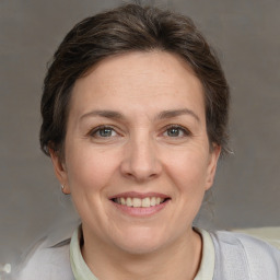 Joyful white adult female with short  brown hair and grey eyes