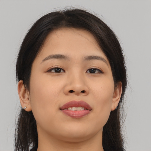 Joyful asian young-adult female with long  brown hair and brown eyes