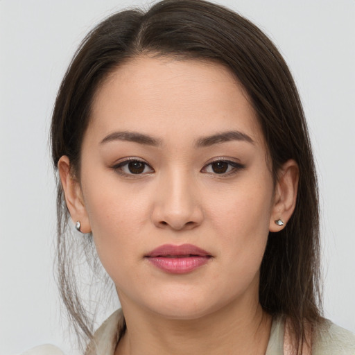 Joyful asian young-adult female with long  brown hair and brown eyes