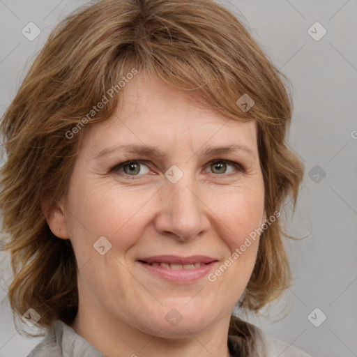 Joyful white adult female with medium  brown hair and grey eyes