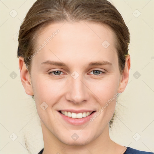 Joyful white young-adult female with medium  brown hair and blue eyes