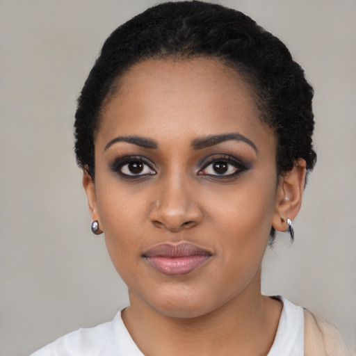 Joyful black young-adult female with medium  black hair and brown eyes