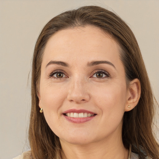 Joyful white young-adult female with long  brown hair and brown eyes