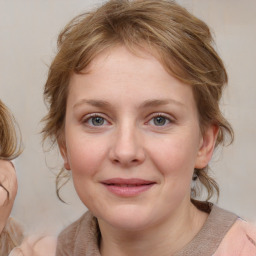 Joyful white young-adult female with medium  brown hair and blue eyes