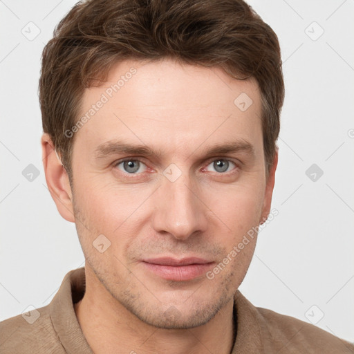 Joyful white young-adult male with short  brown hair and grey eyes