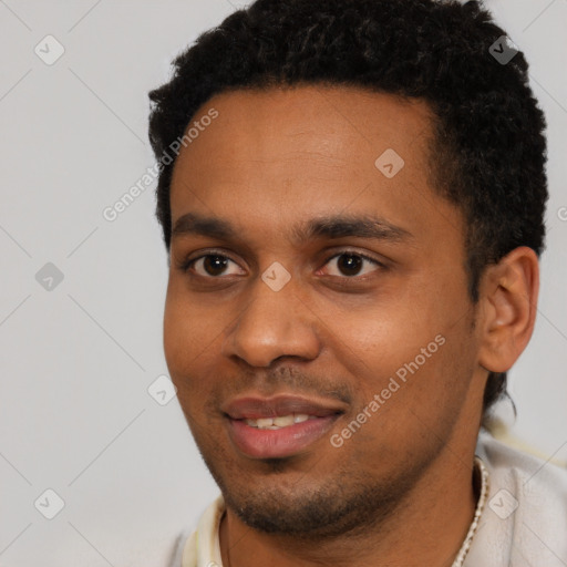Joyful black young-adult male with short  black hair and brown eyes
