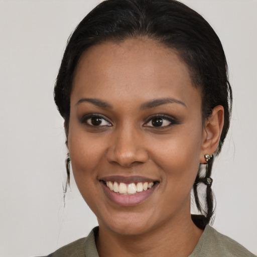 Joyful black young-adult female with medium  black hair and brown eyes