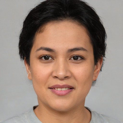 Joyful asian young-adult female with short  brown hair and brown eyes
