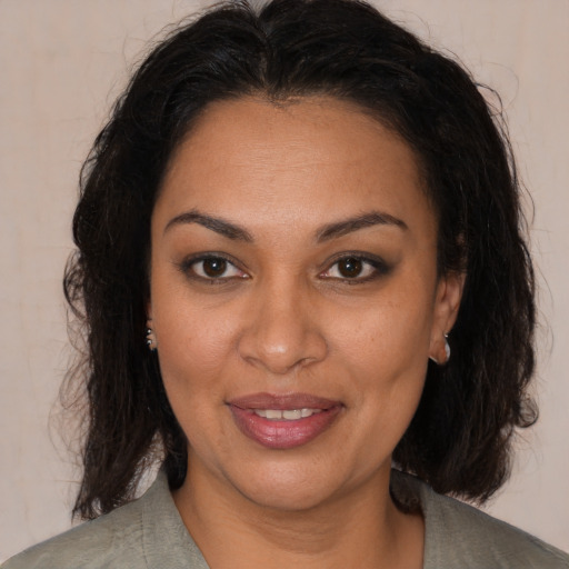 Joyful black young-adult female with medium  brown hair and brown eyes