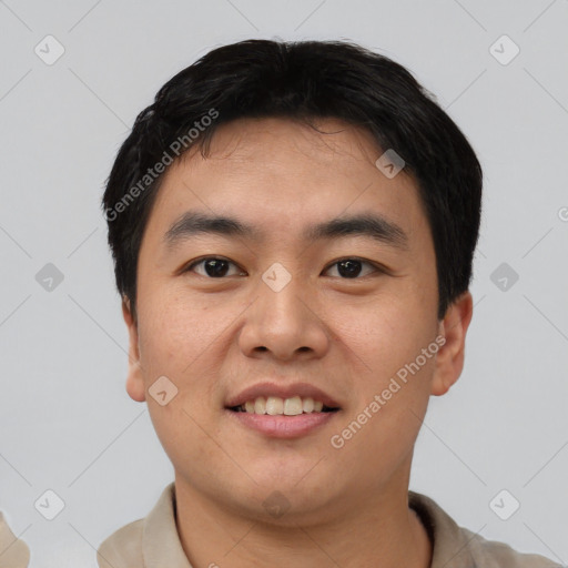 Joyful asian young-adult male with short  black hair and brown eyes