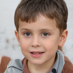 Joyful white child male with short  brown hair and brown eyes