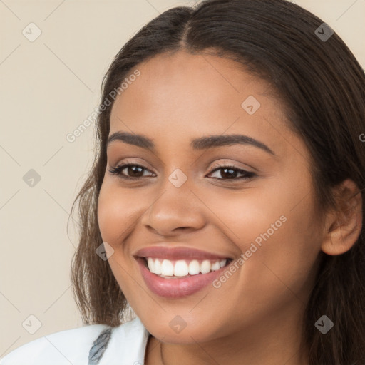 Joyful latino young-adult female with long  brown hair and brown eyes