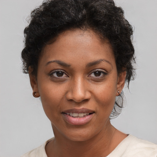 Joyful black young-adult female with short  brown hair and brown eyes
