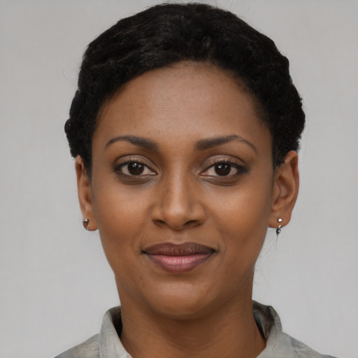 Joyful latino young-adult female with short  black hair and brown eyes