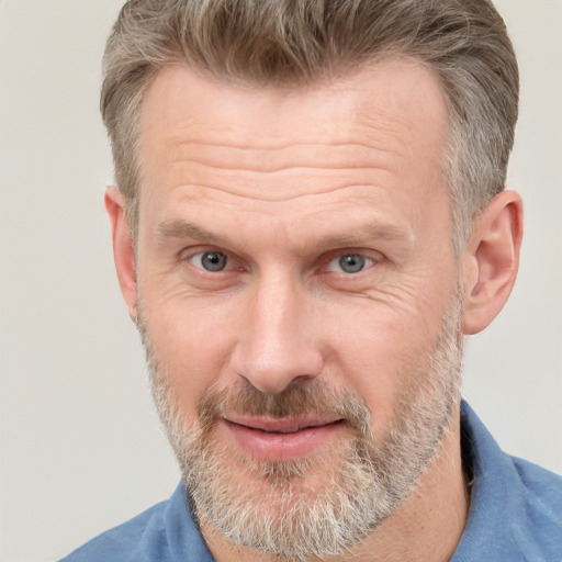 Joyful white middle-aged male with short  brown hair and grey eyes