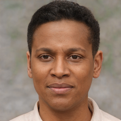 Joyful latino adult male with short  brown hair and brown eyes