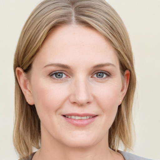 Joyful white young-adult female with medium  brown hair and blue eyes