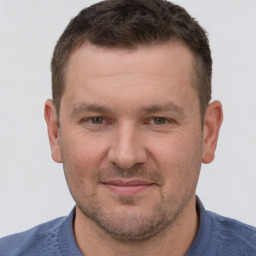 Joyful white adult male with short  brown hair and brown eyes