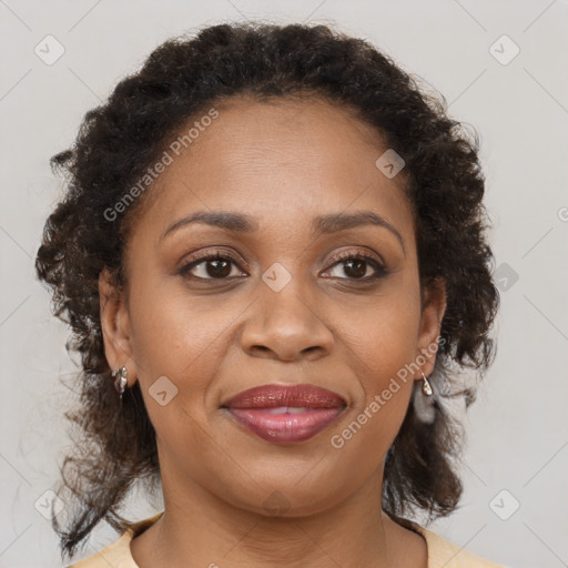 Joyful black adult female with medium  brown hair and brown eyes