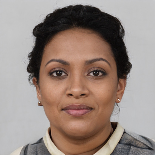 Joyful latino young-adult female with short  brown hair and brown eyes