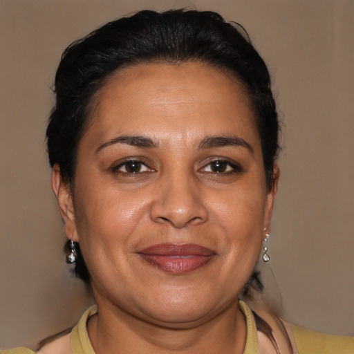 Joyful latino adult female with short  brown hair and brown eyes
