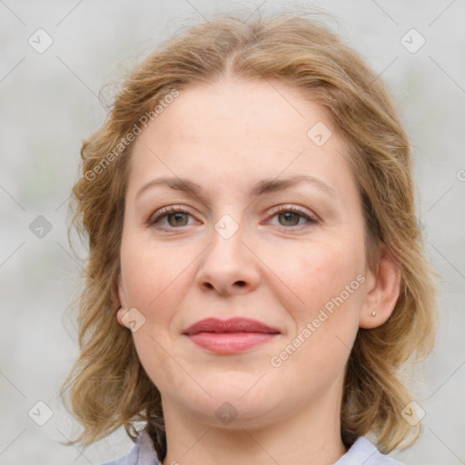 Joyful white young-adult female with medium  brown hair and green eyes