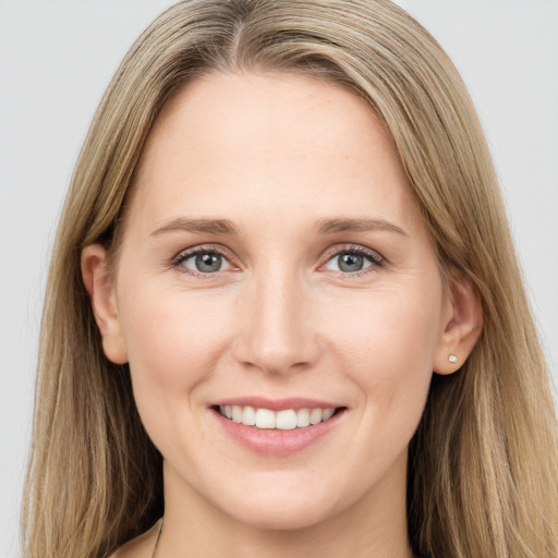 Joyful white young-adult female with long  brown hair and grey eyes