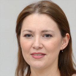 Joyful white young-adult female with long  brown hair and grey eyes