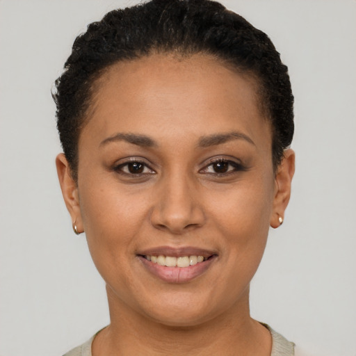 Joyful latino young-adult female with short  black hair and brown eyes