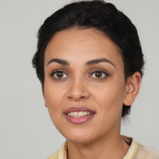 Joyful latino young-adult female with short  brown hair and brown eyes