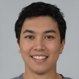 Joyful asian young-adult male with short  black hair and brown eyes