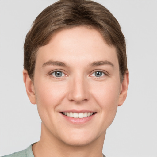 Joyful white young-adult female with short  brown hair and grey eyes