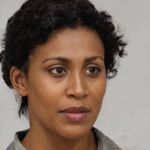Neutral black young-adult female with medium  brown hair and brown eyes