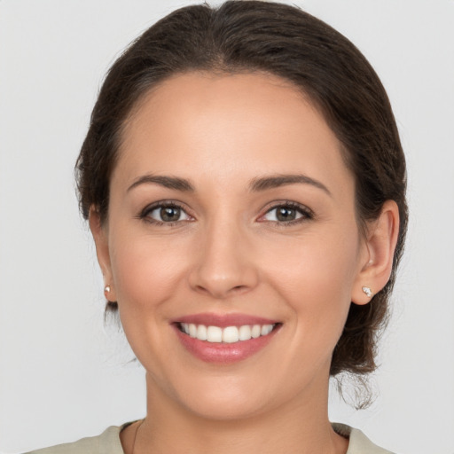 Joyful white young-adult female with medium  brown hair and brown eyes