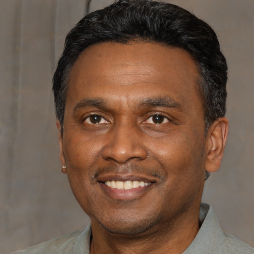 Joyful asian adult male with short  black hair and brown eyes