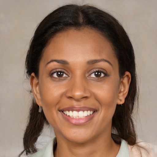 Joyful black young-adult female with medium  brown hair and brown eyes