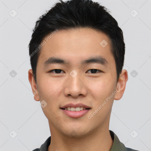 Joyful asian young-adult male with short  black hair and brown eyes