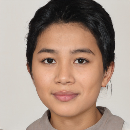 Joyful asian young-adult female with short  black hair and brown eyes