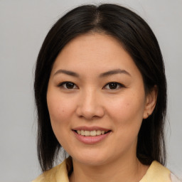 Joyful asian young-adult female with medium  brown hair and brown eyes